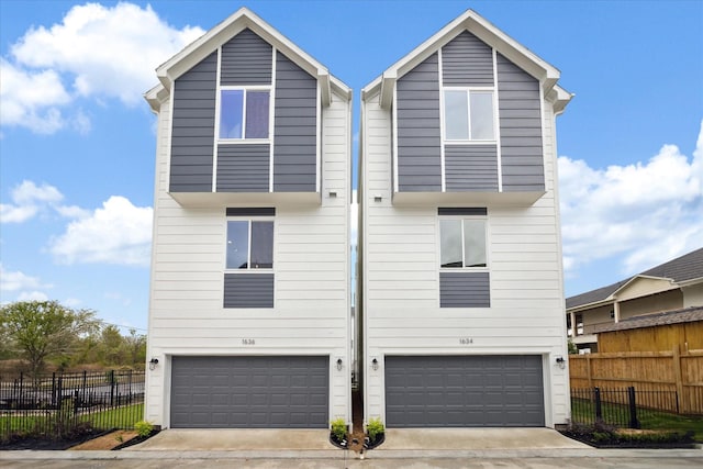 1650 W Tidwell Rd, Houston, TX 77091 - rear view of house featuring an attached garage, fence, and driveway