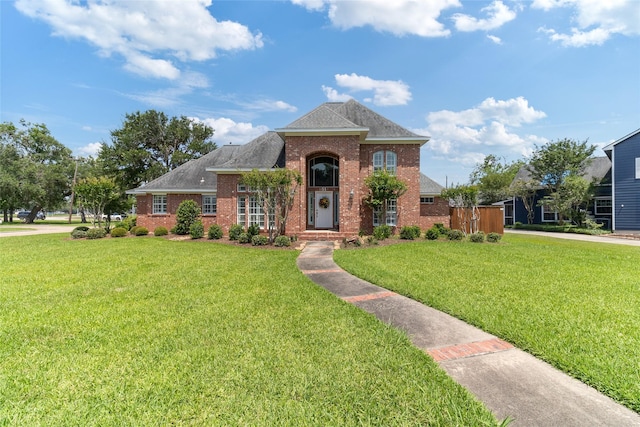 51 Oak Hollow Cir, Lake Jackson, TX 77566 - view of front of property with brick siding, a front lawn, and roof with shingles