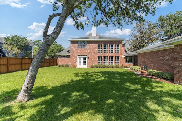 51 Oak Hollow Cir, Lake Jackson, TX 77566 - back of property with a chimney, brick siding, and french doors