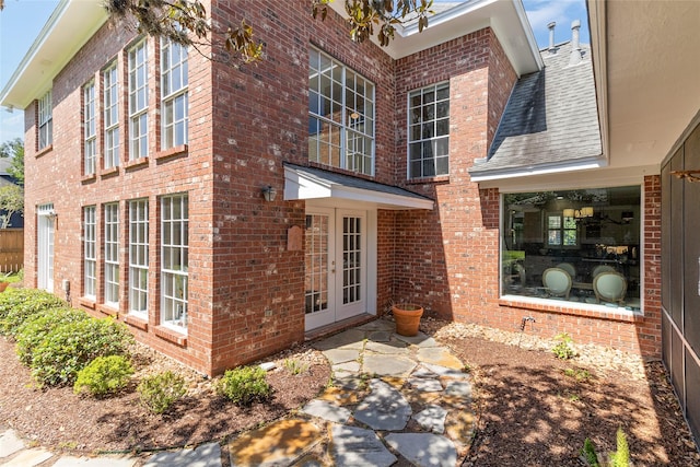 51 Oak Hollow Cir, Lake Jackson, TX 77566 - view of side of property with french doors, brick siding, and a shingled roof