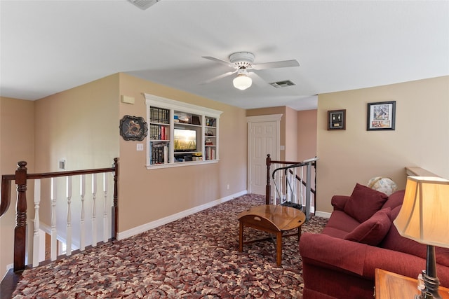51 Oak Hollow Cir, Lake Jackson, TX 77566 - living area featuring an upstairs landing, a ceiling fan, baseboards, carpet floors, and built in shelves