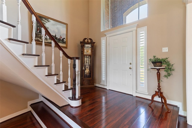 51 Oak Hollow Cir, Lake Jackson, TX 77566 - entrance foyer featuring a towering ceiling, wood finished floors, stairs, and baseboards