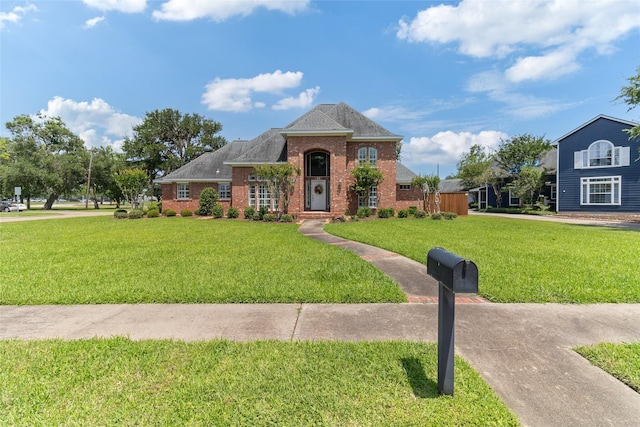 51 Oak Hollow Cir, Lake Jackson, TX 77566 - view of front of home featuring brick siding and a front yard