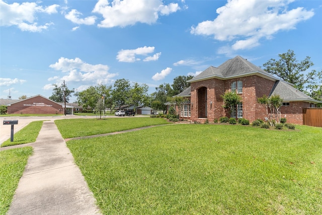 51 Oak Hollow Cir, Lake Jackson, TX 77566 - view of front of house with brick siding and a front lawn