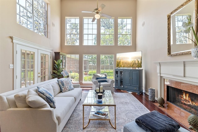 51 Oak Hollow Cir, Lake Jackson, TX 77566 - living room with a high ceiling, dark wood-type flooring, ceiling fan, a fireplace, and plenty of natural light