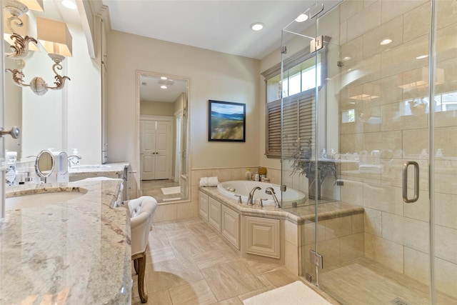 51 Oak Hollow Cir, Lake Jackson, TX 77566 - bathroom featuring a garden tub, a shower stall, vanity, wainscoting, and recessed lighting