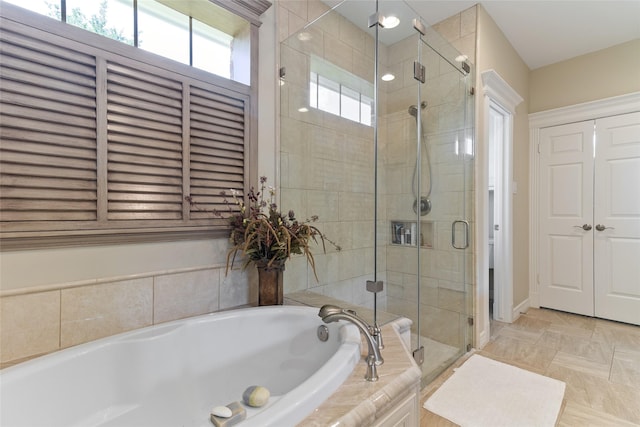 51 Oak Hollow Cir, Lake Jackson, TX 77566 - bathroom with a shower stall, a bath, and plenty of natural light