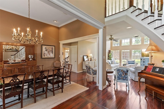 51 Oak Hollow Cir, Lake Jackson, TX 77566 - dining space with a towering ceiling, wood finished floors, stairway, a chandelier, and crown molding