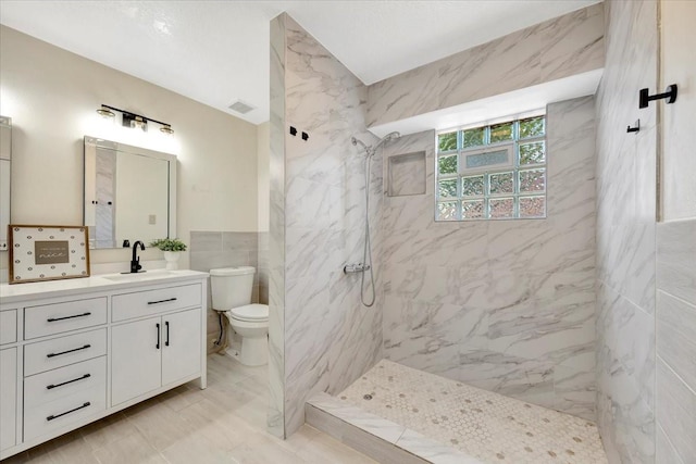 11710 Brettwood Cir, Houston, TX 77089 - full bathroom with toilet, a marble finish shower, vanity, tile walls, and marble finish flooring