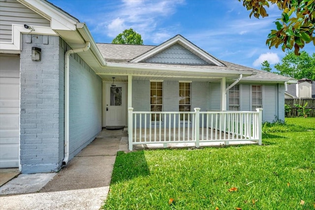 11710 Brettwood Cir, Houston, TX 77089 - view of front of home featuring a porch, a front lawn, a shingled roof, and brick siding