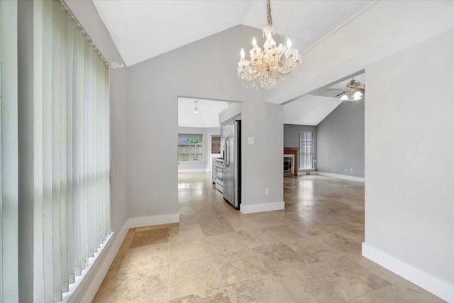 11710 Brettwood Cir, Houston, TX 77089 - unfurnished dining area featuring lofted ceiling, baseboards, a glass covered fireplace, a chandelier, and a ceiling fan