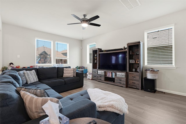 21626 Sage Landing Ln, Katy, TX 77449 - living room featuring a ceiling fan, light wood finished floors, and baseboards