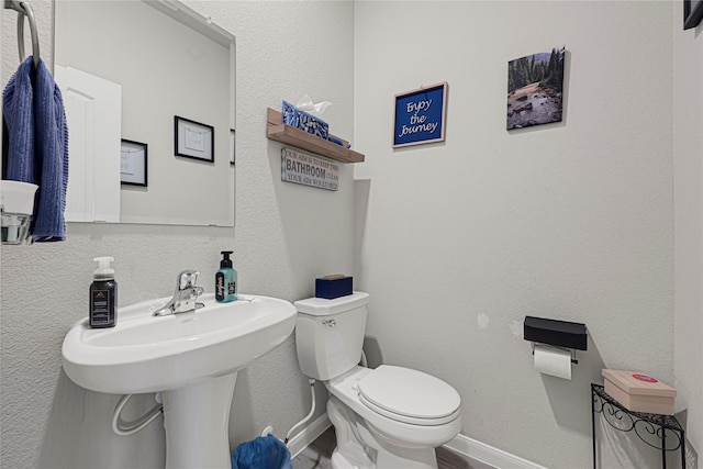 21626 Sage Landing Ln, Katy, TX 77449 - bathroom with toilet, baseboards, and wood finished floors