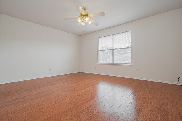 8223 Golf Green Cir, Houston, TX 77036 - empty room with light wood-style flooring, baseboards, and a ceiling fan