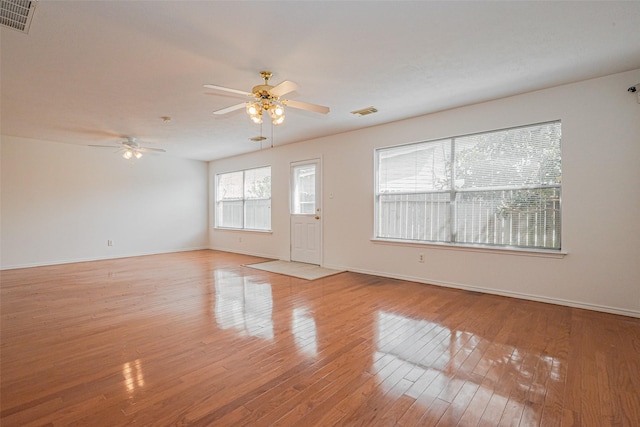 8223 Golf Green Cir, Houston, TX 77036 - unfurnished living room with ceiling fan, light wood-style floors, and baseboards