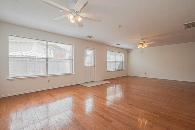 8223 Golf Green Cir, Houston, TX 77036 - unfurnished living room featuring ceiling fan, light wood-style floors, and baseboards