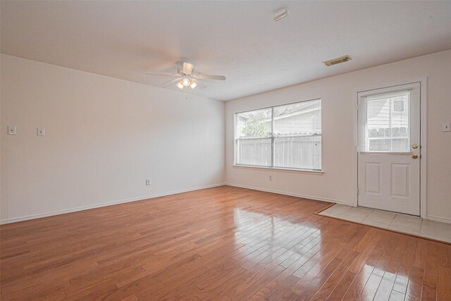 8223 Golf Green Cir, Houston, TX 77036 - spare room with a ceiling fan, light wood-style floors, and baseboards