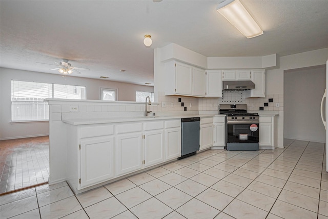 8223 Golf Green Cir, Houston, TX 77036 - kitchen with stainless steel gas range oven, dishwashing machine, a sink, under cabinet range hood, and light countertops