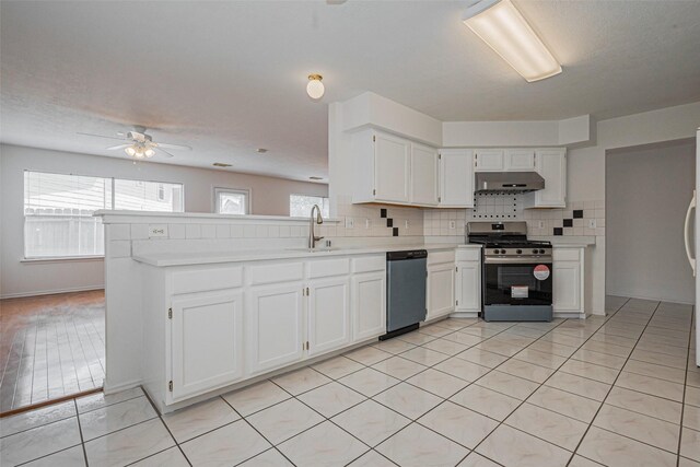 8223 Golf Green Cir, Houston, TX 77036 - kitchen featuring stainless steel appliances, a sink, under cabinet range hood, light countertops, and white cabinetry
