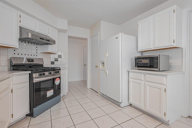 8223 Golf Green Cir, Houston, TX 77036 - kitchen featuring under cabinet range hood, stainless steel appliances, light countertops, and white cabinets