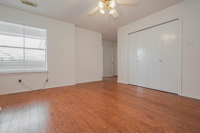 8223 Golf Green Cir, Houston, TX 77036 - unfurnished bedroom featuring wood finished floors, baseboards, a closet, and a ceiling fan