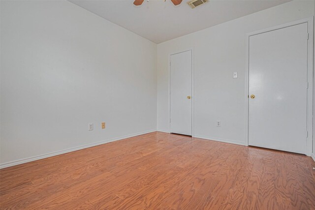 8223 Golf Green Cir, Houston, TX 77036 - unfurnished bedroom with light wood-type flooring, baseboards, and ceiling fan
