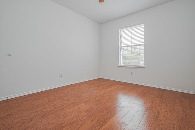 8223 Golf Green Cir, Houston, TX 77036 - unfurnished room featuring wood finished floors, baseboards, and ceiling fan