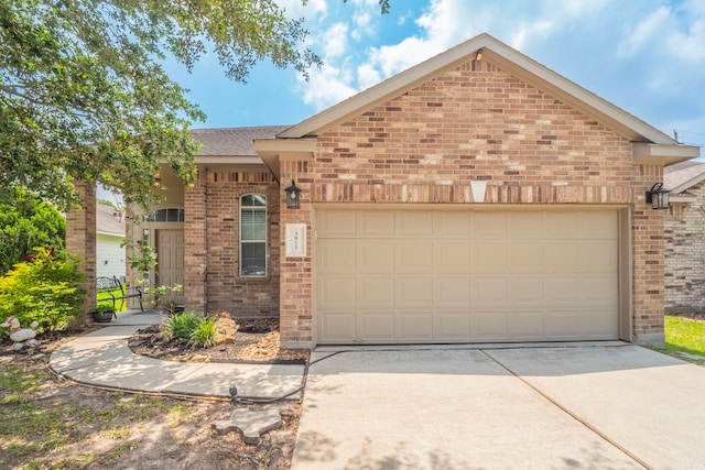 3911 Falvel Cove Dr, Spring, TX 77388 - view of front of house featuring brick siding, a garage, and driveway