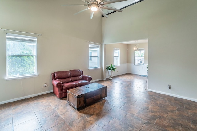 3911 Falvel Cove Dr, Spring, TX 77388 - living room with high vaulted ceiling, baseboards, ceiling fan, and a chandelier