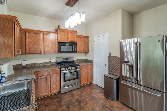 3911 Falvel Cove Dr, Spring, TX 77388 - kitchen with stainless steel appliances, brown cabinets, dark countertops, and stone finish floors