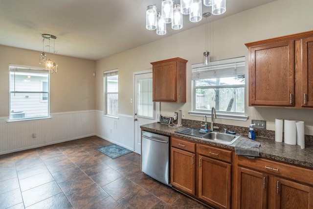 3911 Falvel Cove Dr, Spring, TX 77388 - kitchen featuring dishwasher, a sink, a chandelier, a wainscoted wall, and brown cabinetry