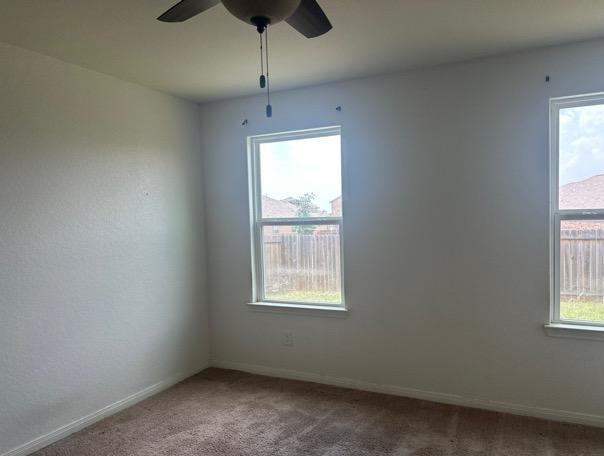 15215 Snug Harbor Way, Von Ormy, TX 78073 - spare room with carpet floors, healthy amount of natural light, and a ceiling fan