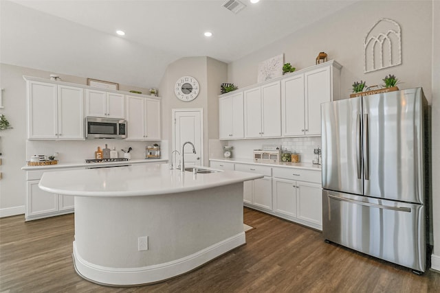 26415 Polaris Rise Ln, Richmond, TX 77406 - kitchen with stainless steel appliances, a sink, white cabinets, lofted ceiling, and recessed lighting