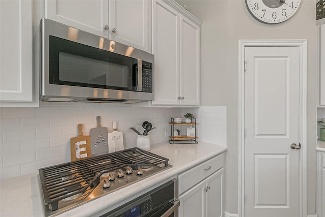 26415 Polaris Rise Ln, Richmond, TX 77406 - kitchen featuring stainless steel appliances, white cabinets, tasteful backsplash, and light countertops