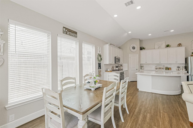 26415 Polaris Rise Ln, Richmond, TX 77406 - dining space featuring light wood finished floors, vaulted ceiling, recessed lighting, and baseboards