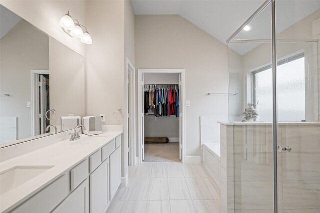 26415 Polaris Rise Ln, Richmond, TX 77406 - bathroom featuring vaulted ceiling, a garden tub, double vanity, baseboards, and an enclosed shower