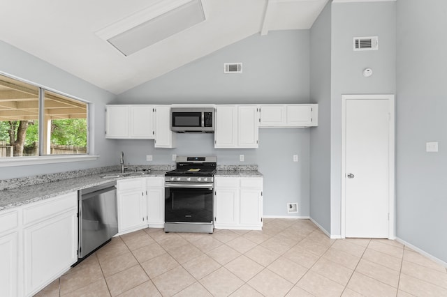 9702 Pale Star Dr, Houston, TX 77064 - kitchen with appliances with stainless steel finishes, a sink, high vaulted ceiling, light stone counters, and white cabinets