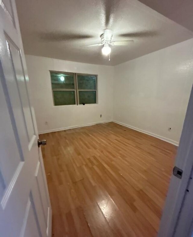 5625 Antoine Dr Unit 705, Houston, TX 77091 - empty room with ceiling fan, wood finished floors, and baseboards