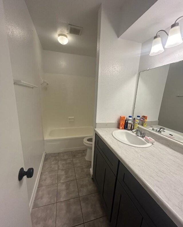 5625 Antoine Dr Unit 705, Houston, TX 77091 - bathroom with tile patterned floors, toilet, vanity, bathing tub / shower combination, and baseboards