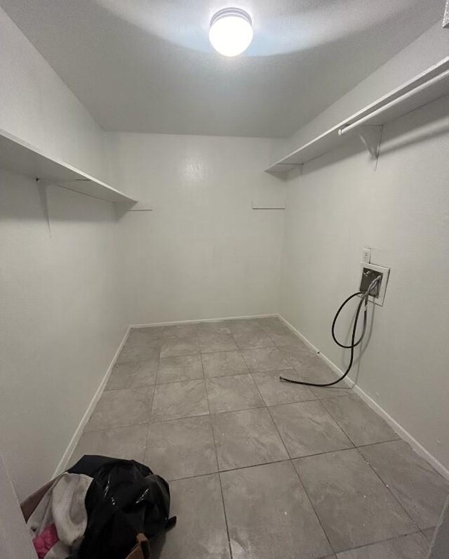 5625 Antoine Dr Unit 705, Houston, TX 77091 - washroom with washer hookup, baseboards, and tile patterned flooring