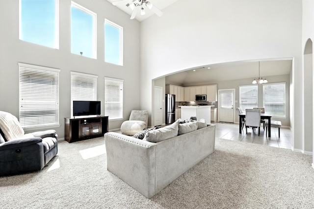 32719 Oak Heights Ln, Brookshire, TX 77423 - living area with arched walkways, a high ceiling, light colored carpet, a chandelier, and a ceiling fan