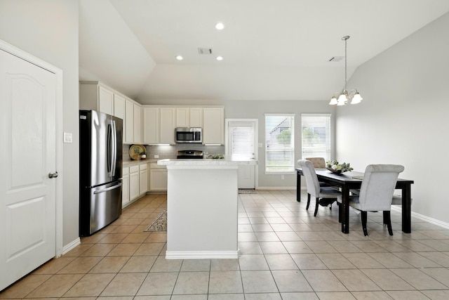 32719 Oak Heights Ln, Brookshire, TX 77423 - kitchen featuring stainless steel appliances, lofted ceiling, light countertops, light tile patterned floors, and a kitchen island