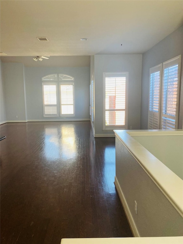 3123 Dallas St, Houston, TX 77003 - spare room featuring dark wood-style flooring, baseboards, and plenty of natural light