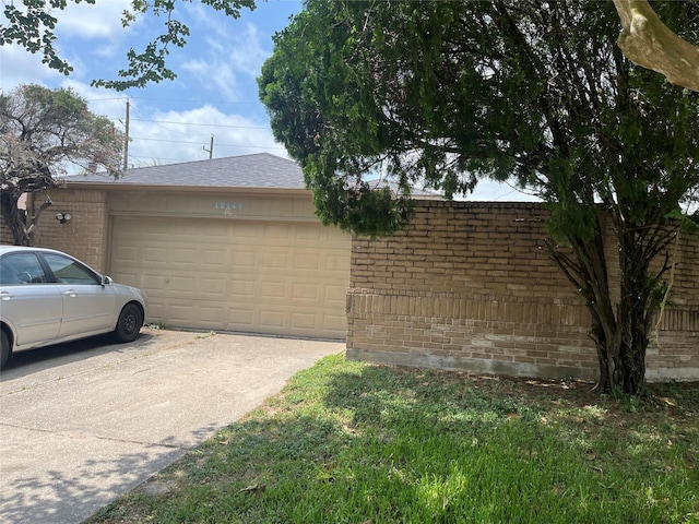 12147 Swords Creek Rd, Houston, TX 77067 - view of side of home featuring brick siding, a garage, concrete driveway, and roof with shingles