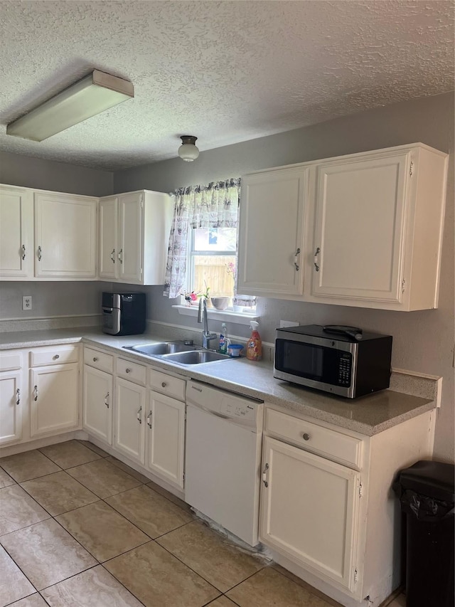 12147 Swords Creek Rd, Houston, TX 77067 - kitchen with dishwasher, stainless steel microwave, a sink, white cabinets, and a textured ceiling