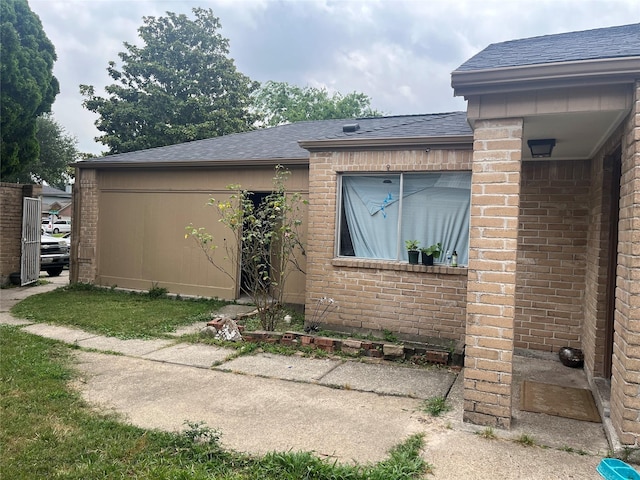 12147 Swords Creek Rd, Houston, TX 77067 - view of home's exterior with a shingled roof and brick siding