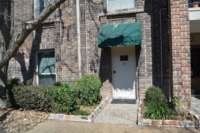 7575 Katy Fwy Unit 9, Houston, TX 77024 - doorway to property with brick siding