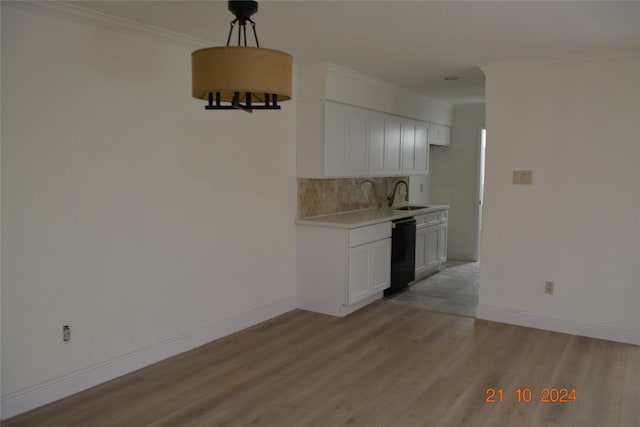7575 Katy Fwy Unit 9, Houston, TX 77024 - unfurnished dining area with a sink, light wood-type flooring, crown molding, and baseboards