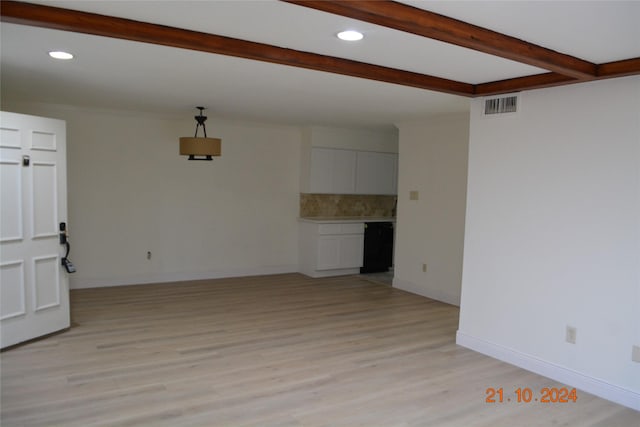 7575 Katy Fwy Unit 9, Houston, TX 77024 - unfurnished living room with beam ceiling, light wood-type flooring, recessed lighting, and baseboards