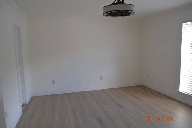 7575 Katy Fwy Unit 9, Houston, TX 77024 - spare room with crown molding, light wood-style flooring, and baseboards